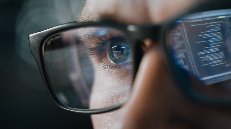 Close-up Portrait of Software Engineer Working on Computer, Line of Code Reflecting in Glasses. Developer Working on Innovative e-Commerce Application using Machine Learning, AI Algorithm, Big Data